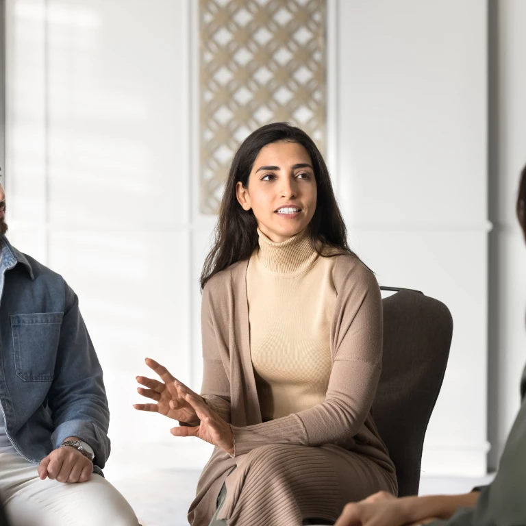 2536390999 - Group therapy female Latin doctor talking to diverse patients on support meeting
