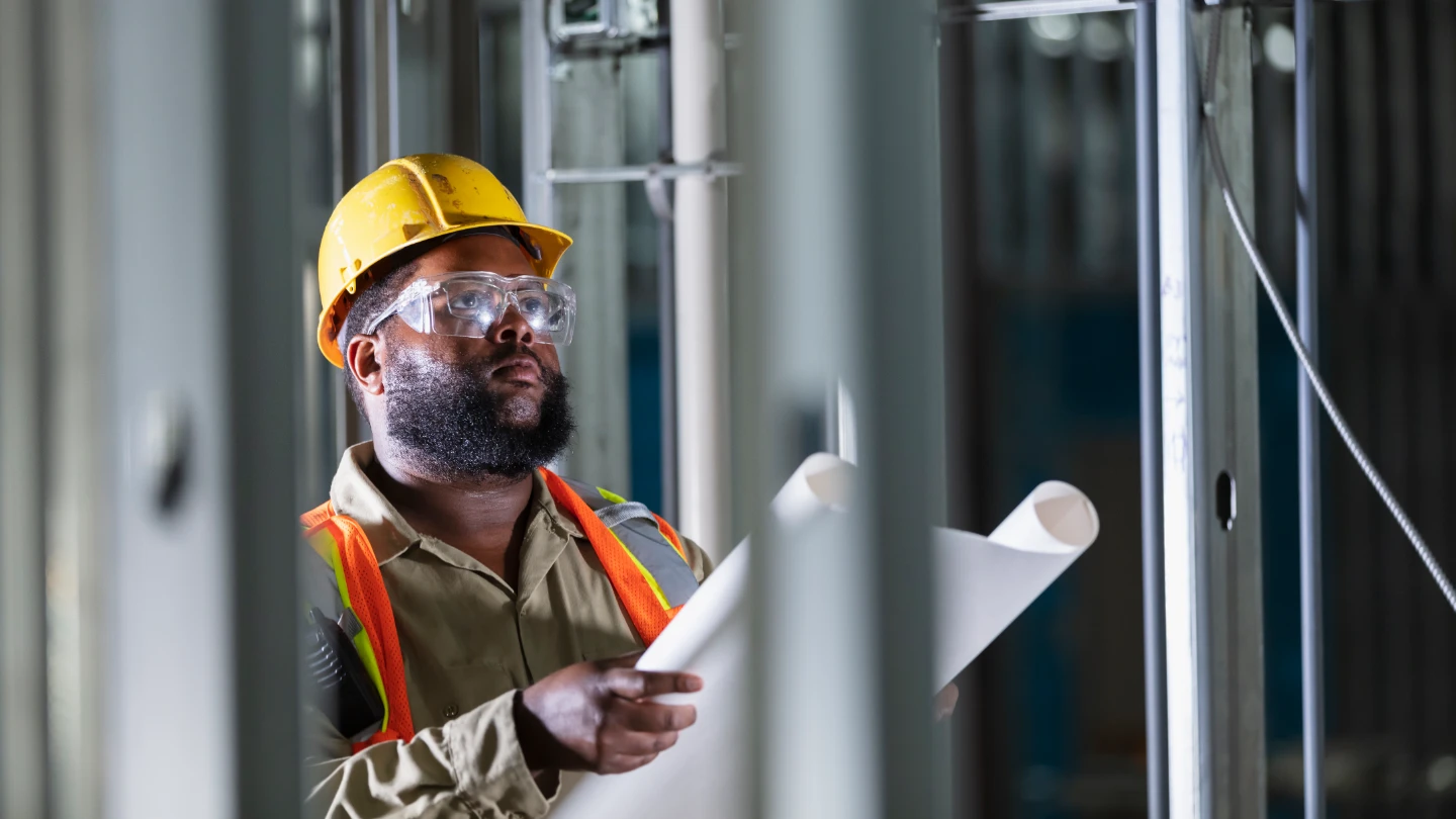 construction worker reviewing drawings