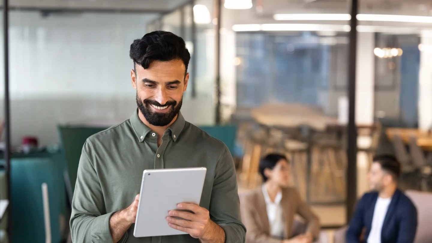 2743685031 - Smiling Middle Eastern businessman using digital tablet