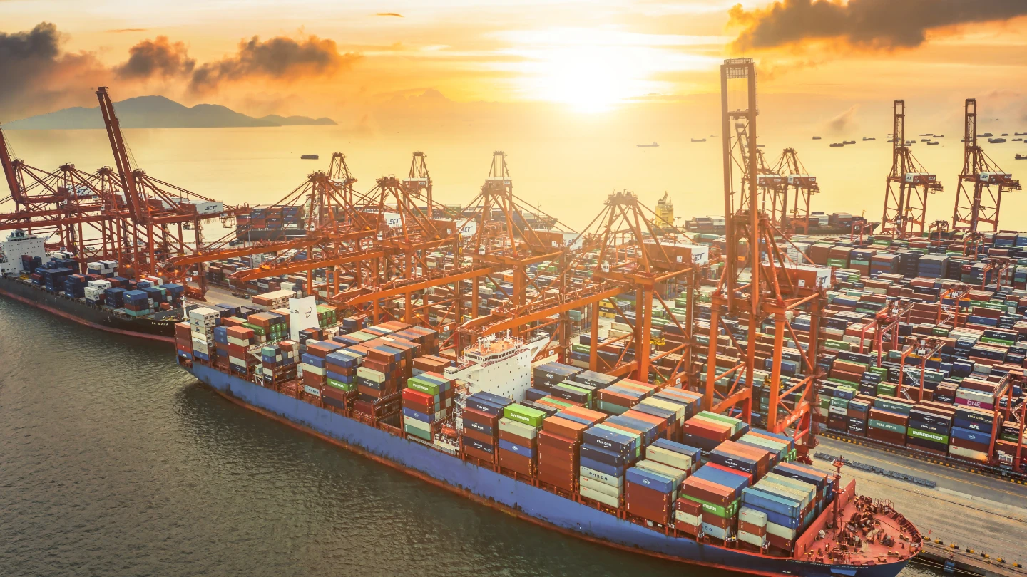 Aerial view of large ship in dock with containers